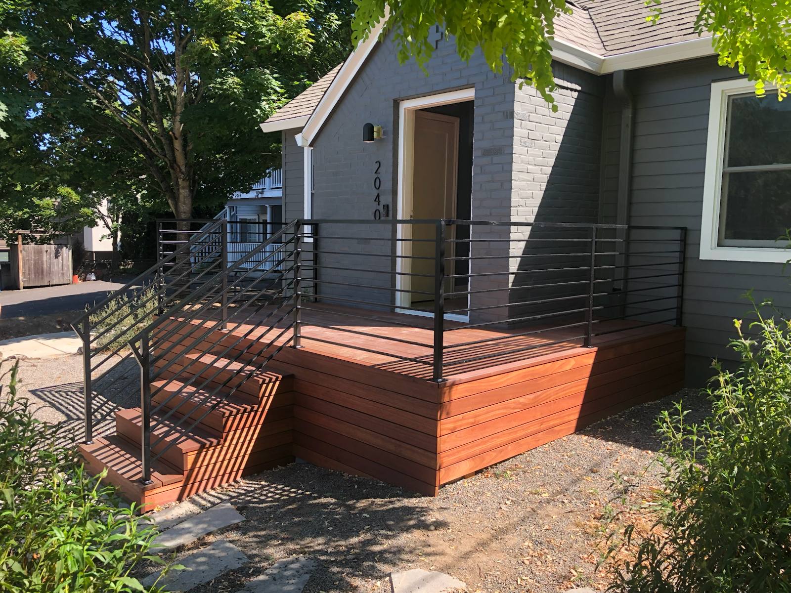 Black metal porch railing and step handrail in a Portland-area home