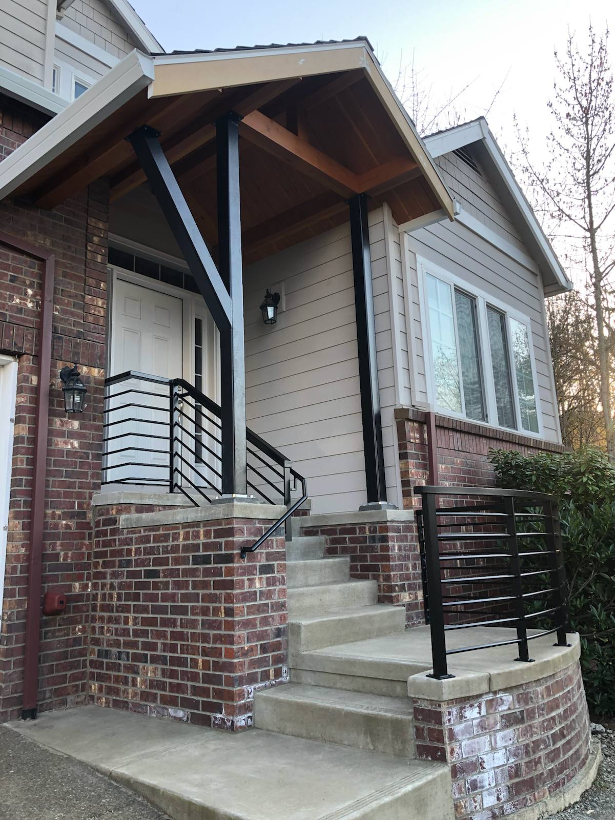 Black metal handrail on concrete front steps — Portland, OR