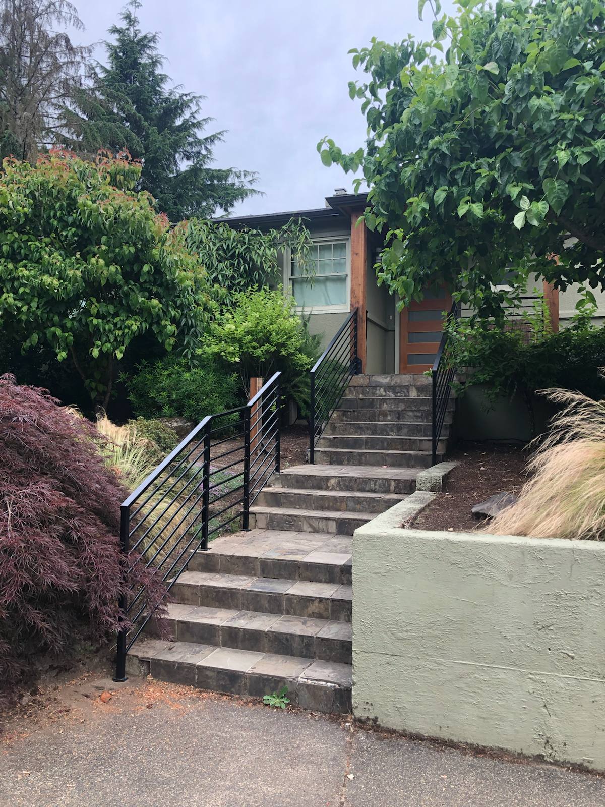 Black metal handrail on concrete front steps — Vancouver, WA area