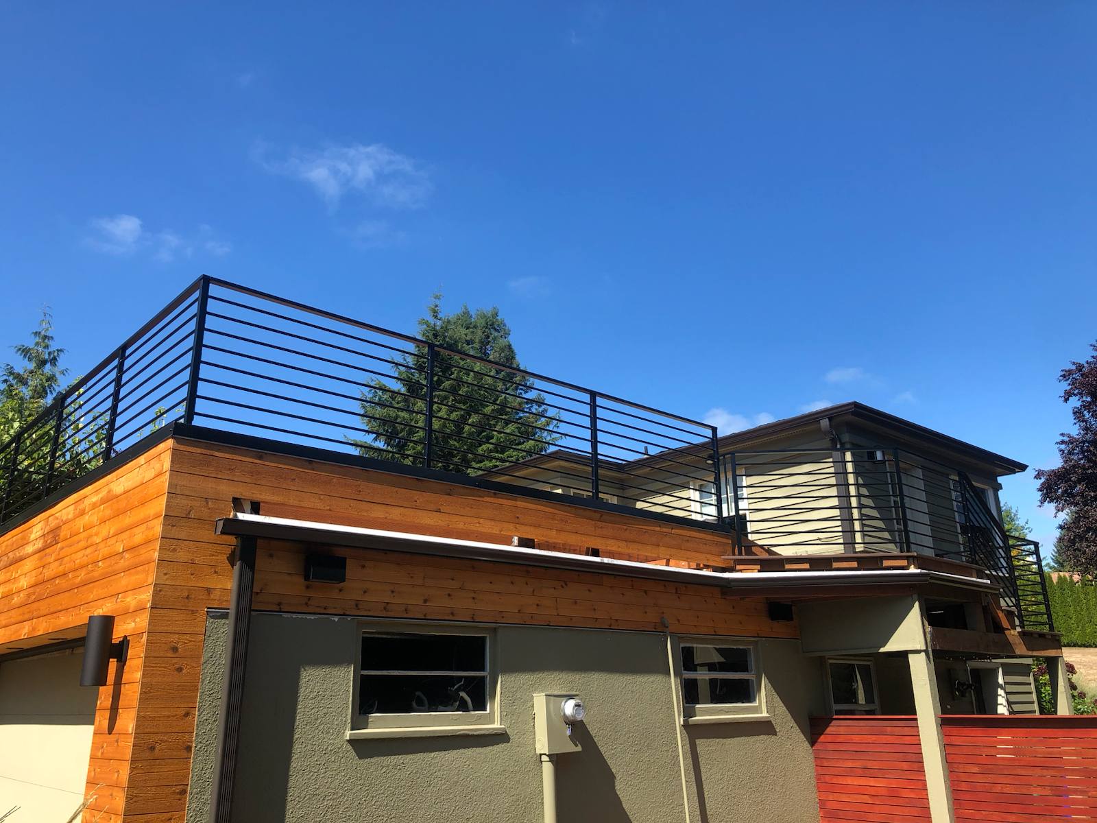 Black metal rooftop deck railing on a floating home in a Portland-area home
