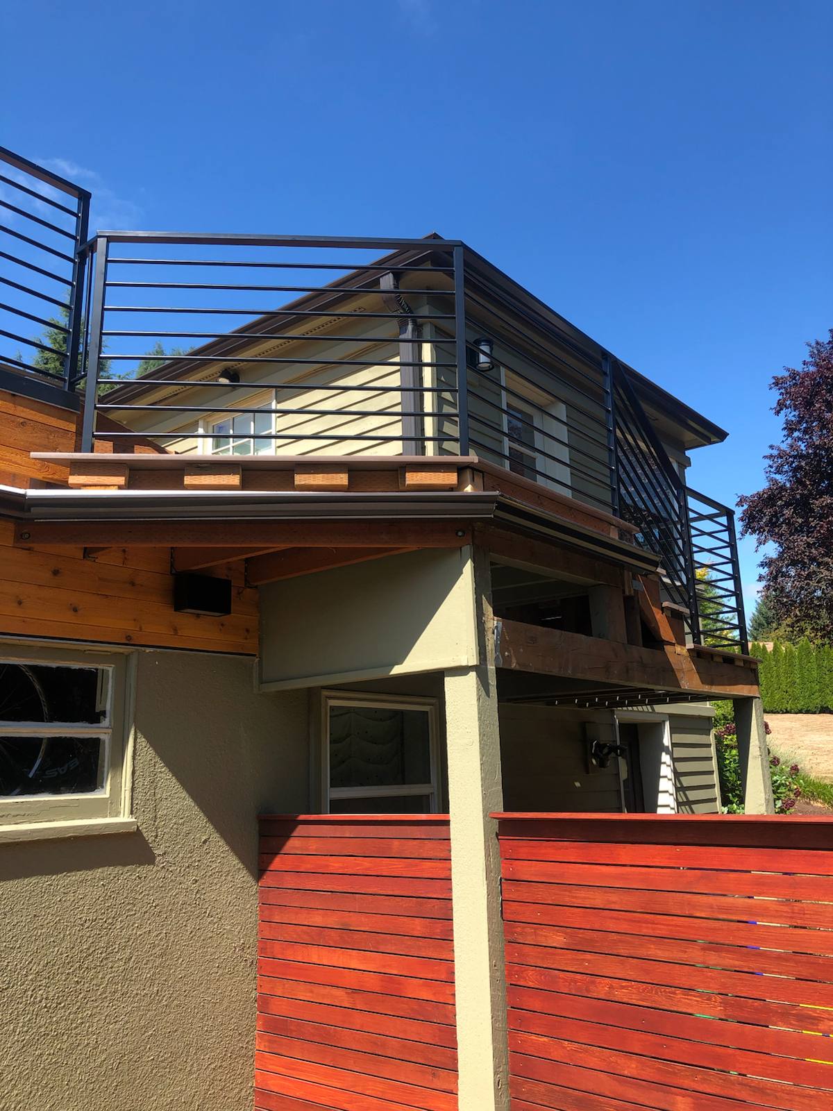 Black metal rooftop deck railing on a floating home by Cascade Mobile Welding