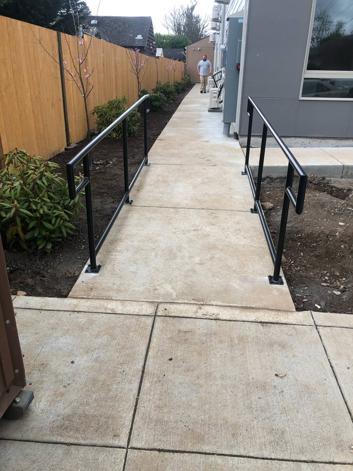 Metal handrail along an outdoor walkway and steps — custom metalwork, Portland