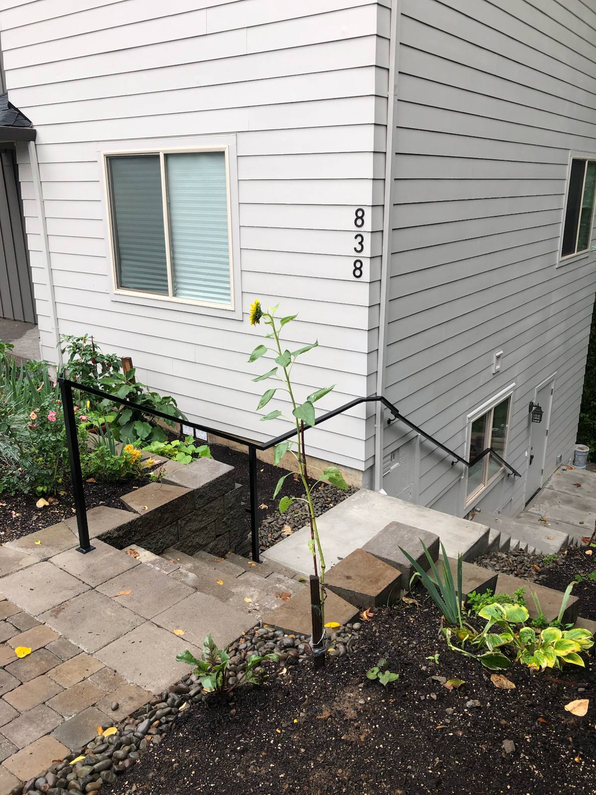 Black metal handrail on concrete front steps — Vancouver, WA area