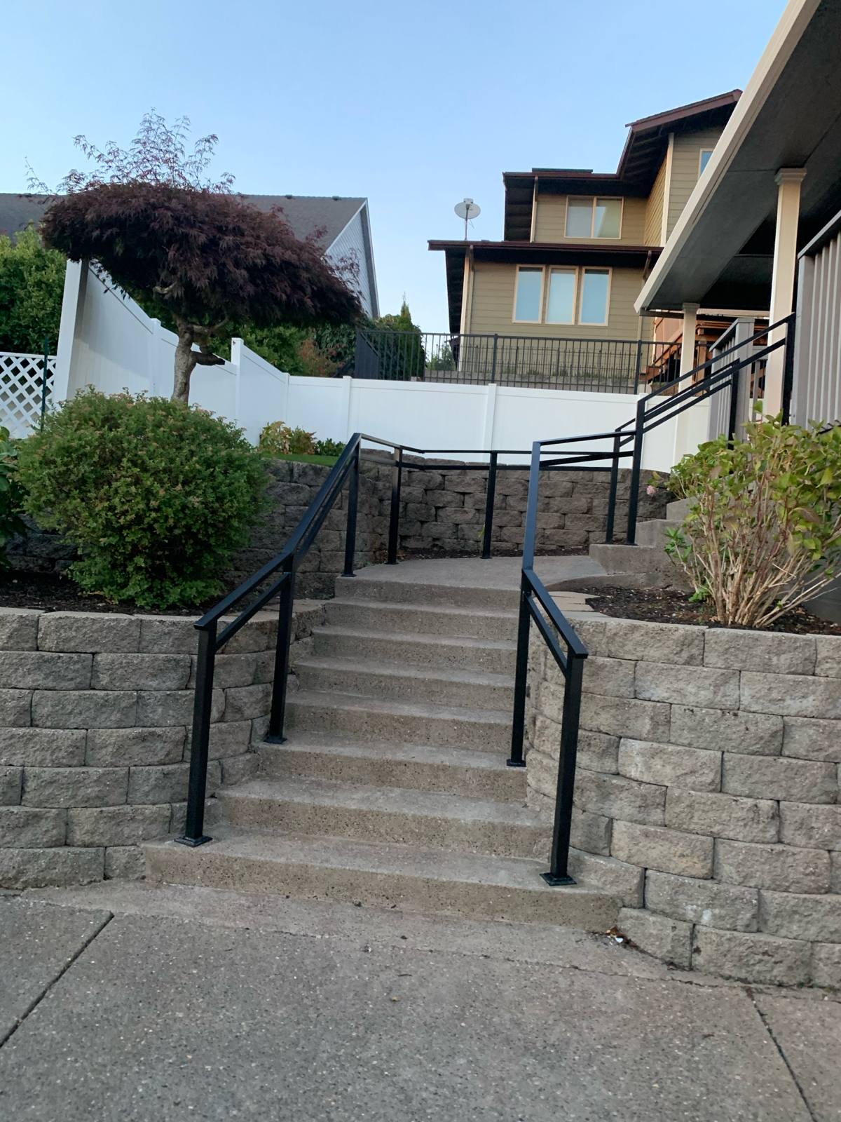 Metal handrail along an outdoor walkway and steps in a Portland-area home