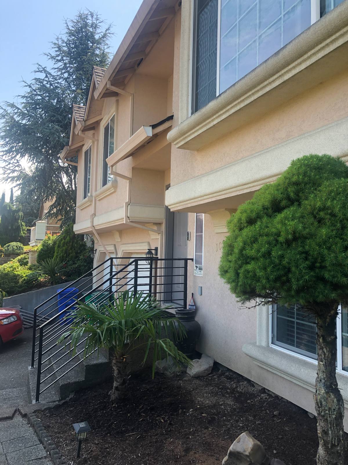 Black metal handrail on concrete front steps — Portland, OR