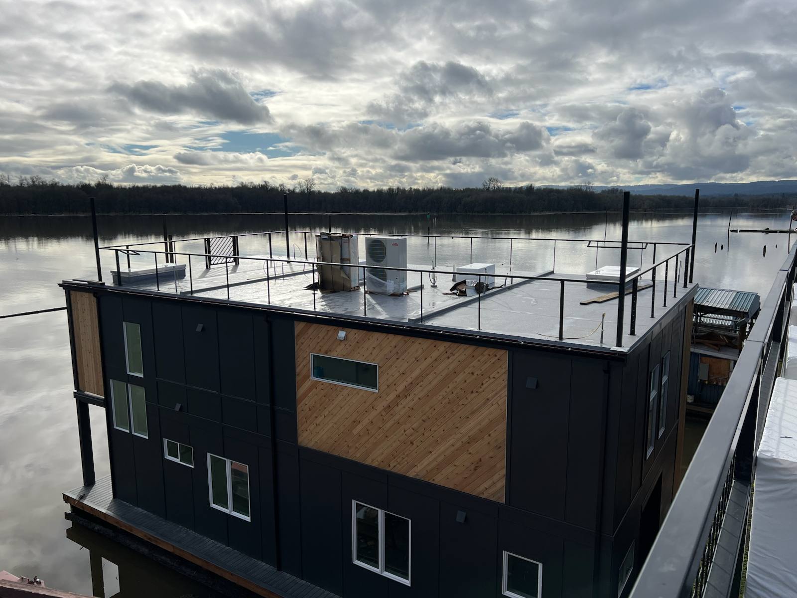 Black metal rooftop deck railing on a floating home — Vancouver, WA area