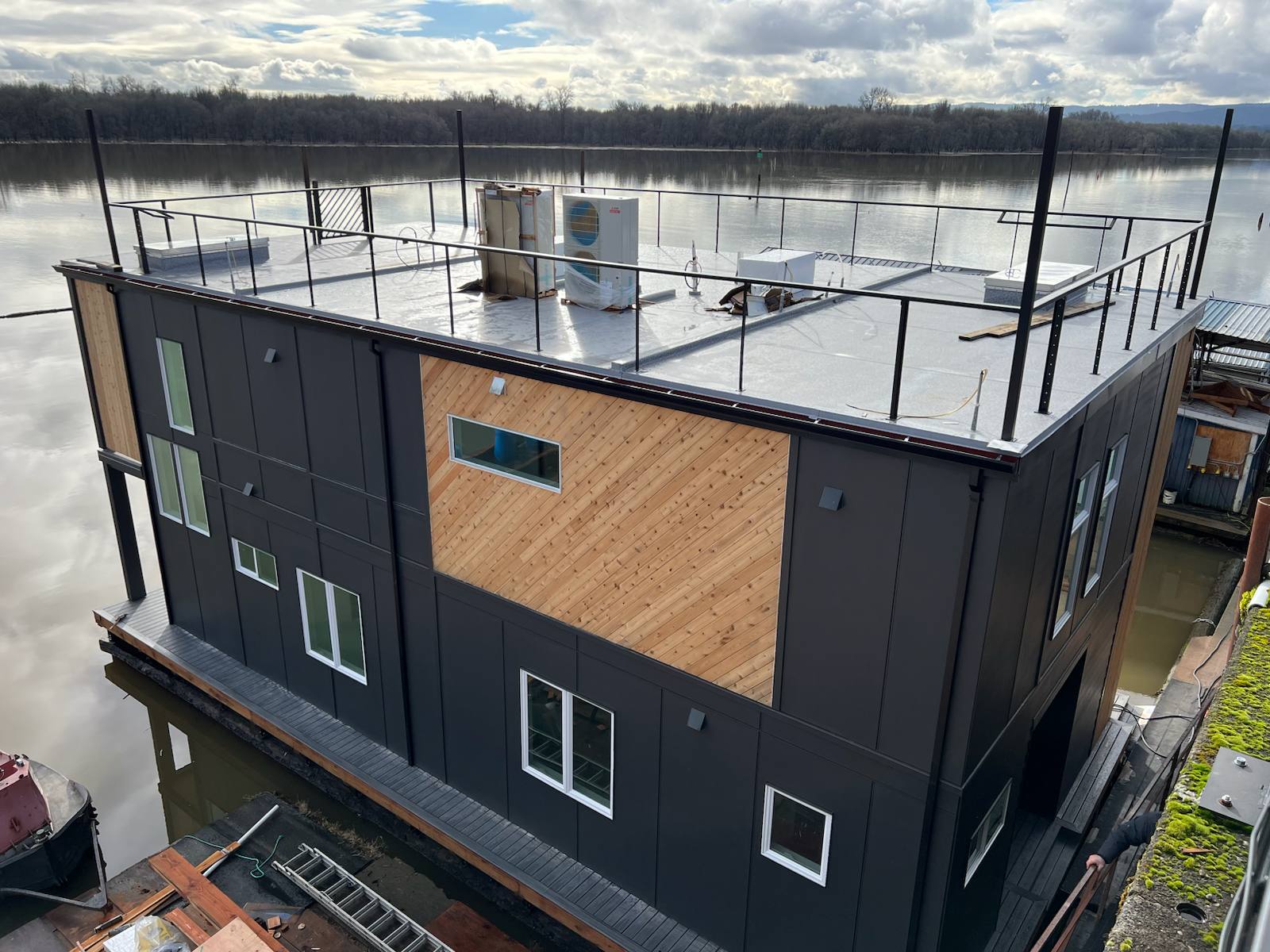 Black metal rooftop deck railing on a floating home — custom metalwork, Portland