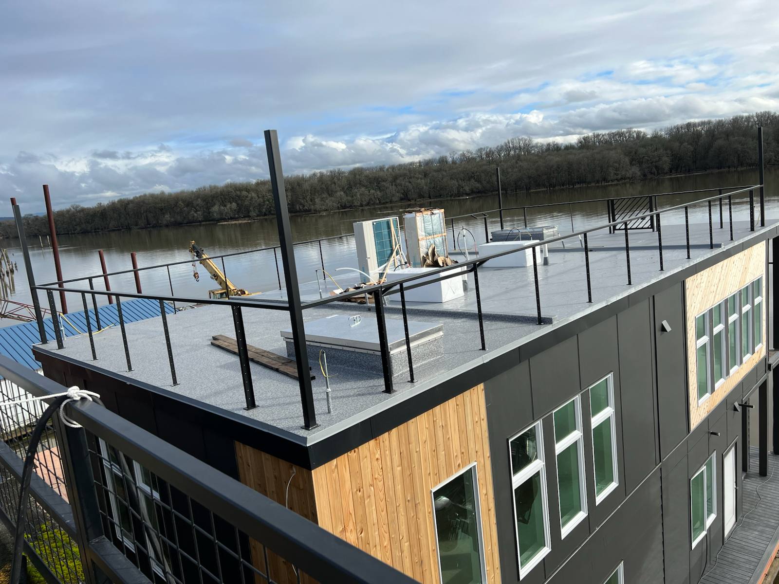Black metal rooftop deck railing on a floating home — Portland, OR