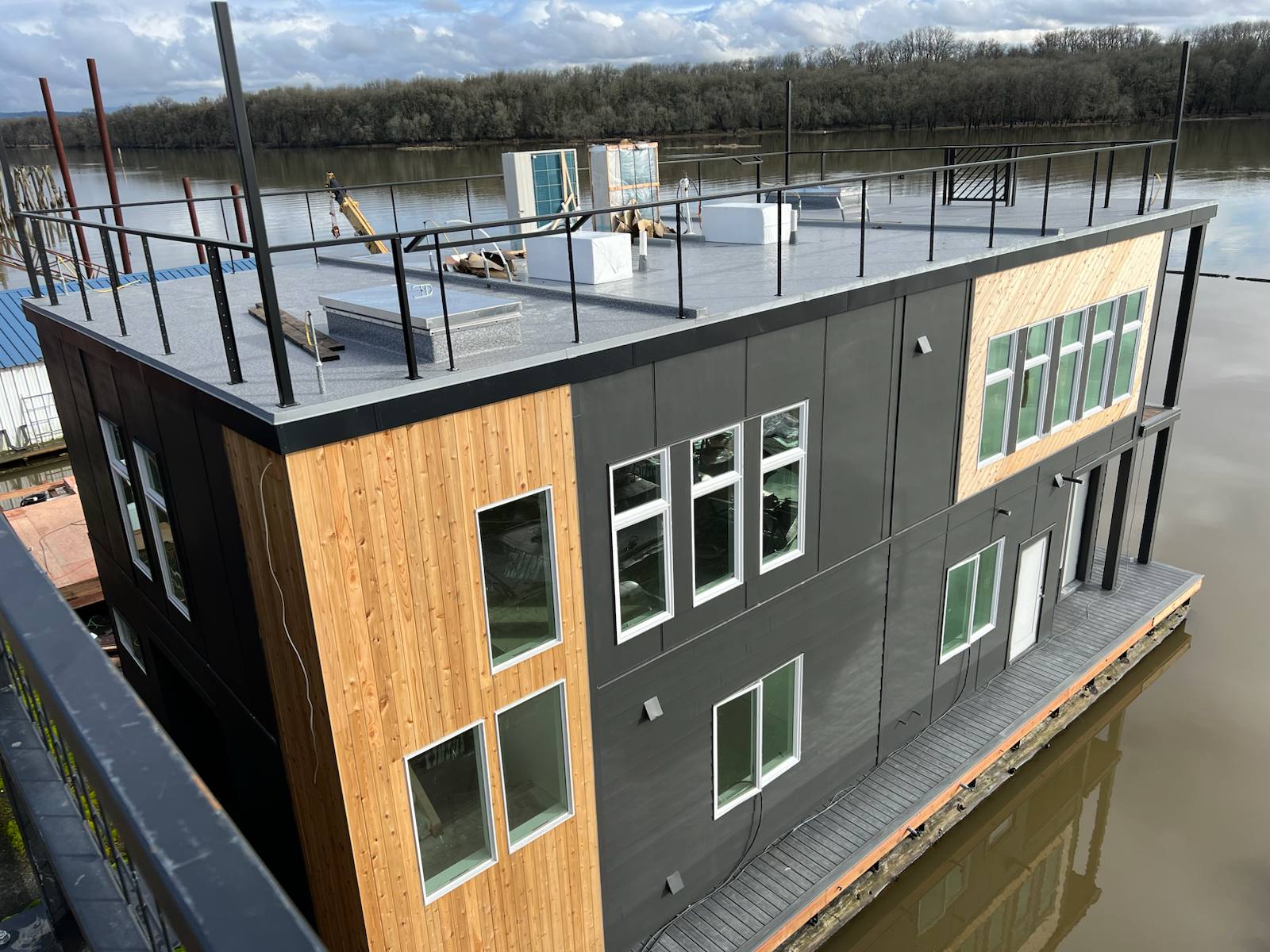 Black metal rooftop deck railing on a floating home in a Portland-area home
