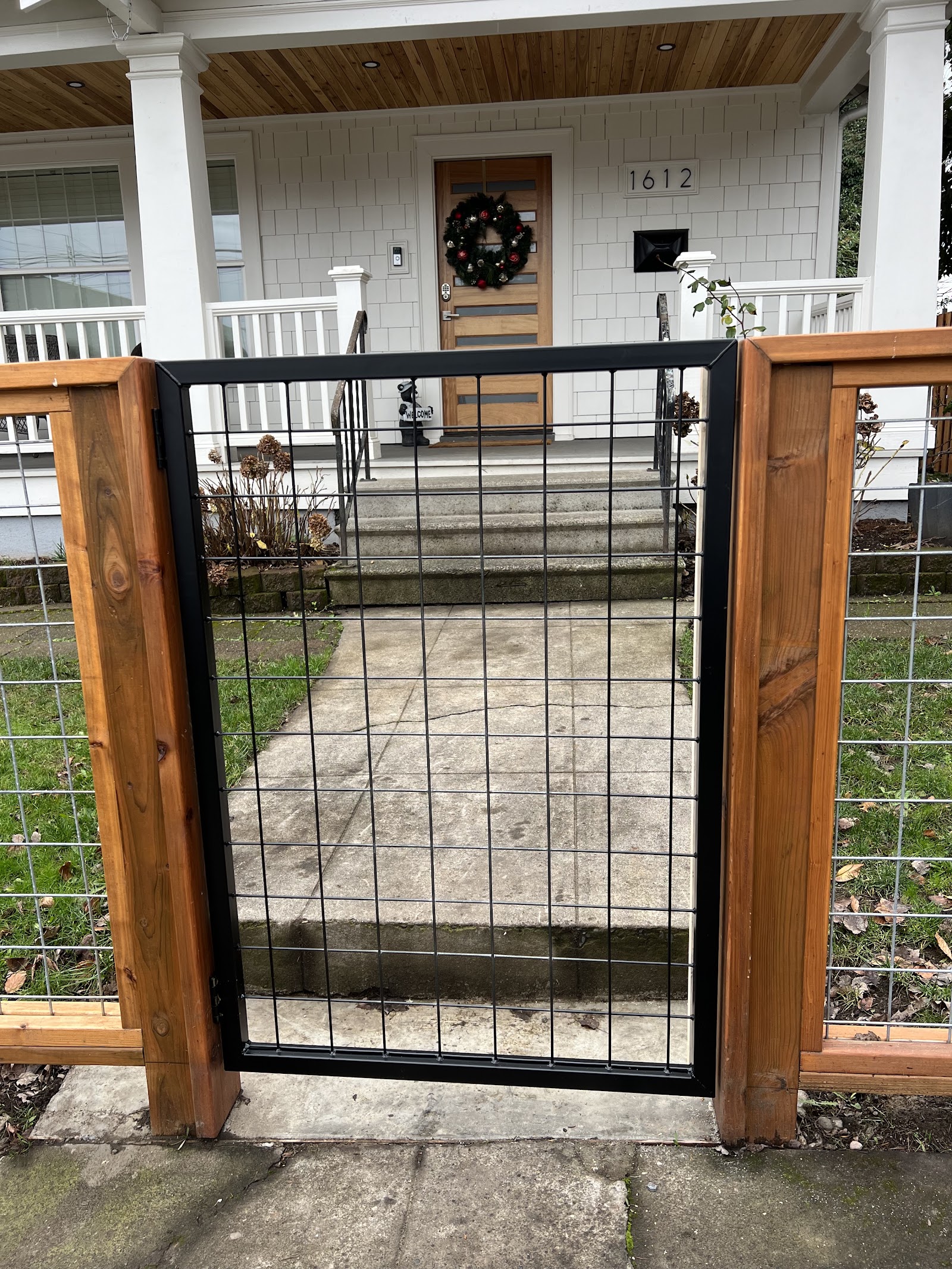 Steel-framed hog-wire walk gate with cedar posts