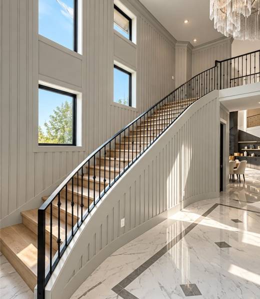 Curved staircase with custom black wrought iron railing